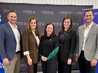 Groupe de personnes posant devant un mur promotionnel de Lepage Millwork et une bannière d’Investissement Québec lors d’un événement officiel.